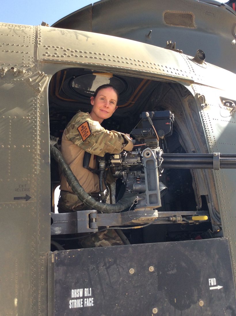 Liz dressed in uniform sitting at the door of a Chinook