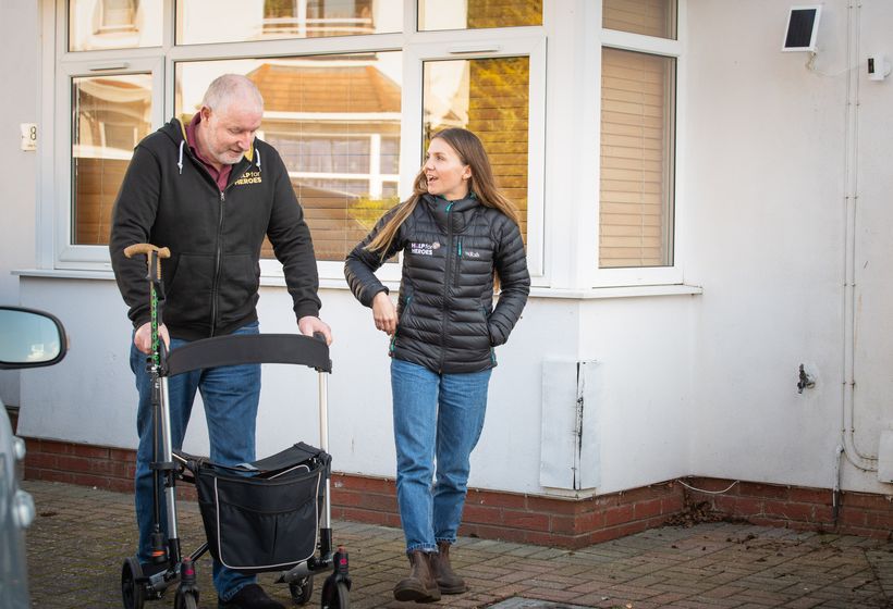 Martin walks outside with Hannah from H4H as they smile and chat