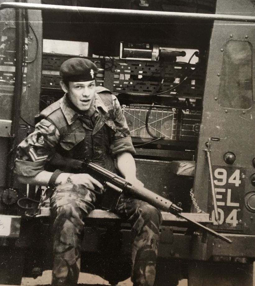 Image shows Geoff in his uniform with a rifle.