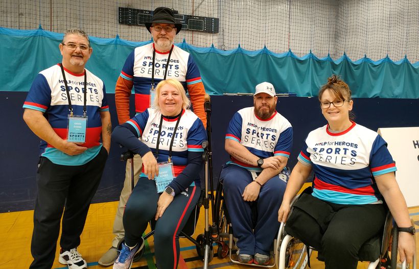 Martin stands with a group of veterans looking happy