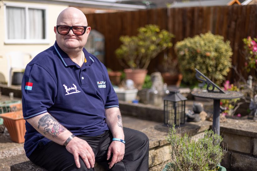 Shaun sits outside, smiling