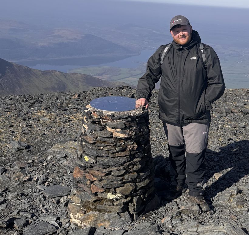 Image shows George Bean wearing walking gear