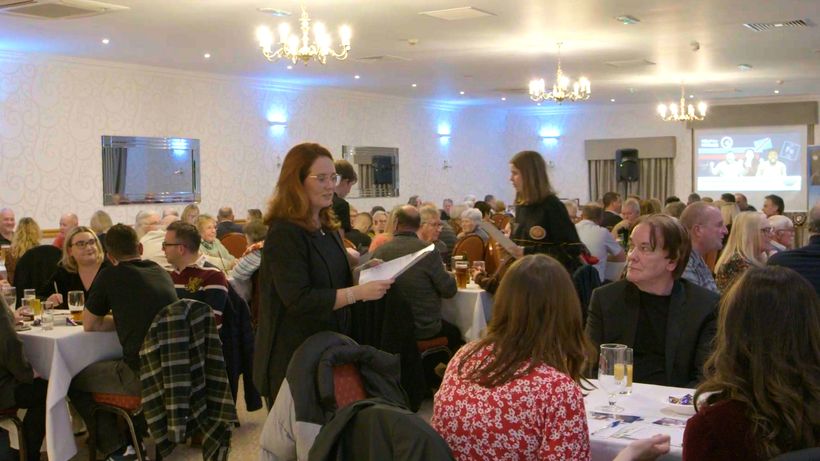 Photo of Quiz participants, with some people stood up