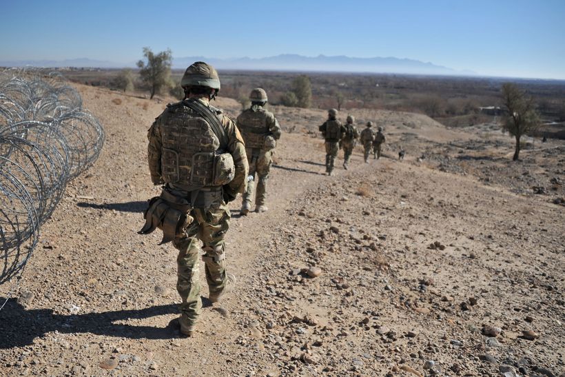 UK troops on patrol in Afghanistan in military uniform.