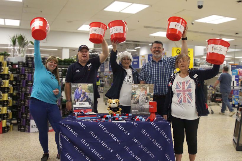 Help for Heroes volunteers smiling & holding up buckets