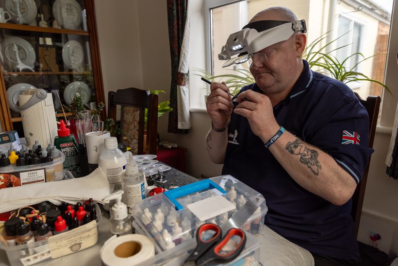 Shaun wears his glasses painting small models