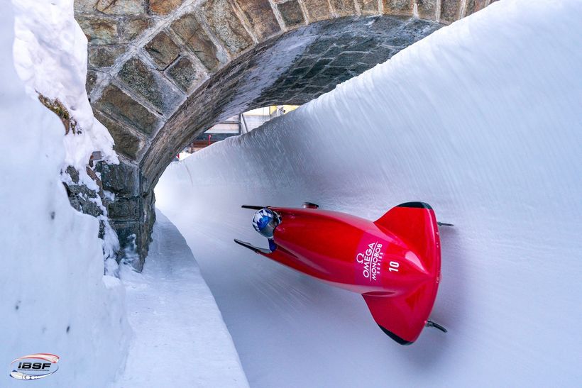 Corie in his red bobsleigh speeding down the ice track