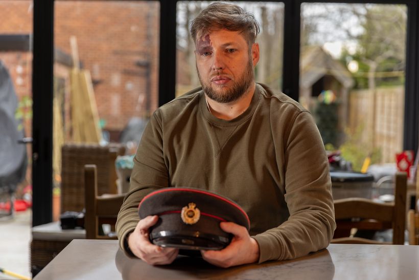 Craig sitting looking reflectively at his Army cap