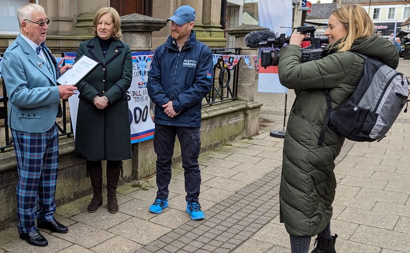 TV camera pointed at four people