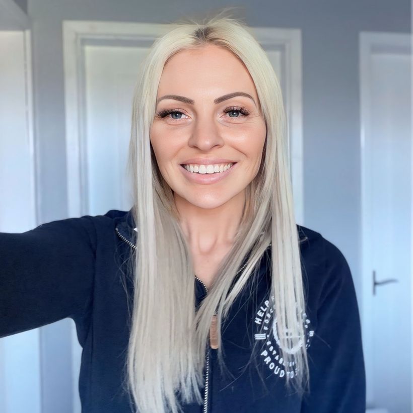 Image shows Simone wearing a navy blue hoodie