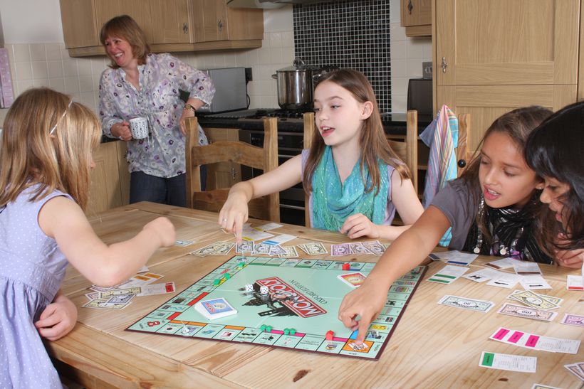 Children play the board game monopoly together
