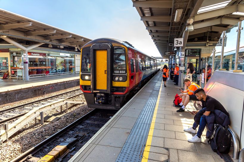 Outdoor train platform with passengers waiting