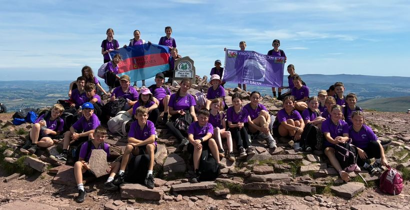 School children sat together at the top of Pen-y-Fan in Wales