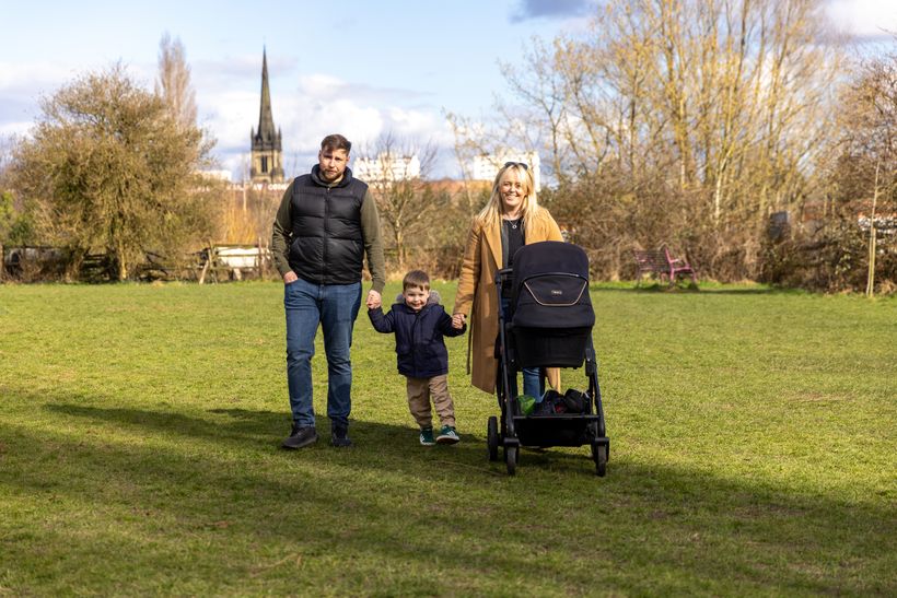 Craig walking in park with wife and son, with baby in pushchair