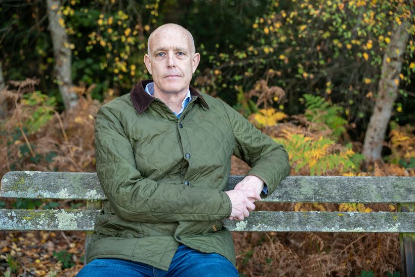 Gareth sits on bench