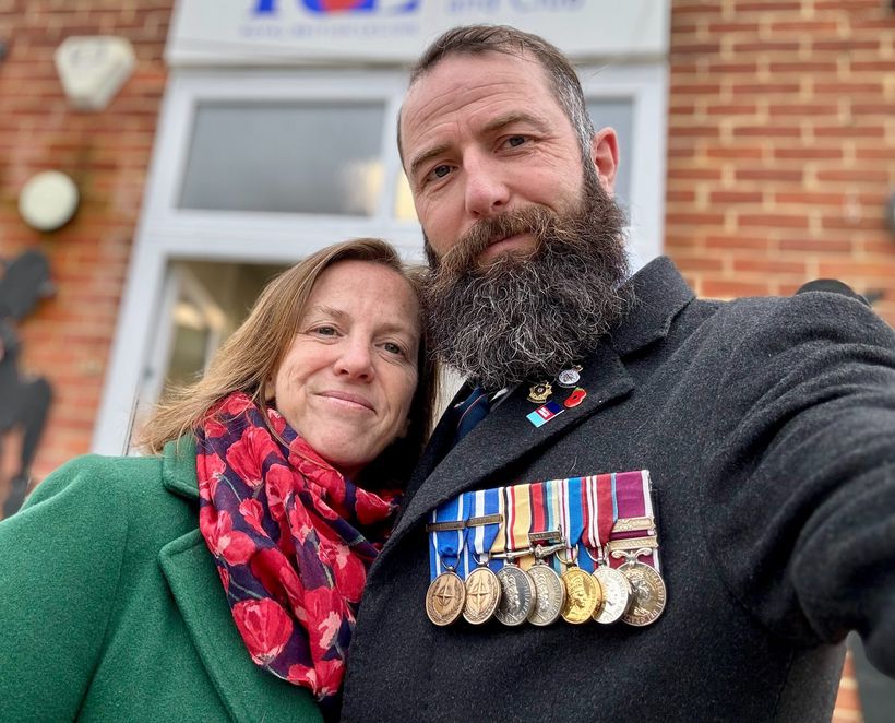 Soldier wearing medals poses with his partner