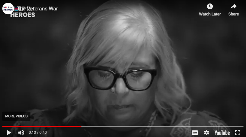 Black and white footage of veterans faces as they are asked whether they have found peace
