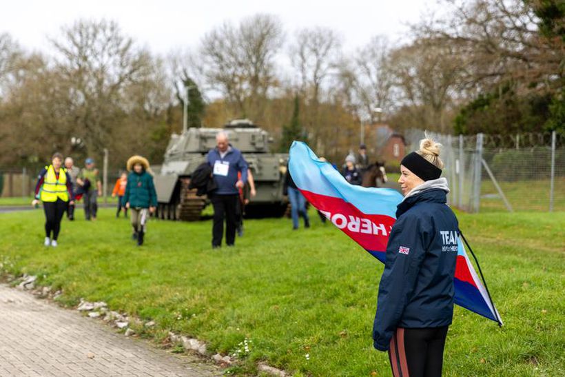 Flag being waved to welcome finishers on Walk to Remember