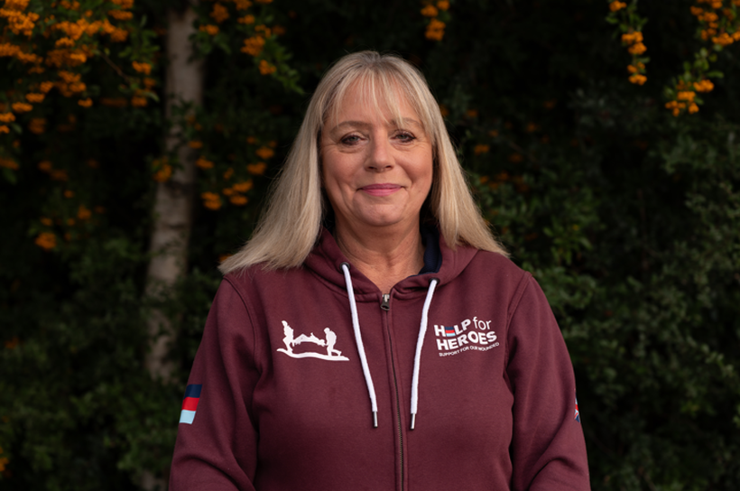 Case manager Yvonne smiles wearing a Help for Heroes hoodie