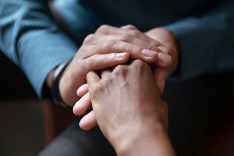 Two people holding hands