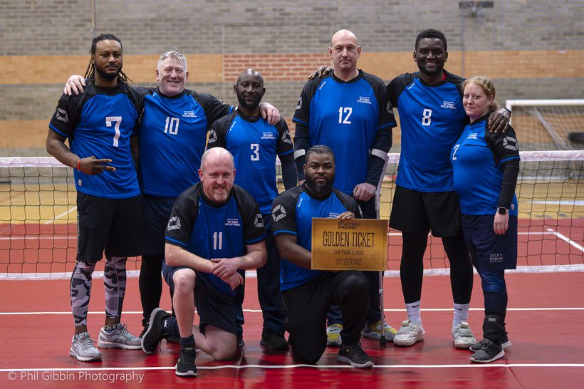 A team shot of sitting volleyball players.