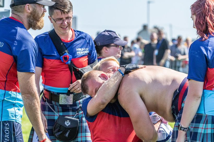 David hugging teammates at the Mey Highland Games