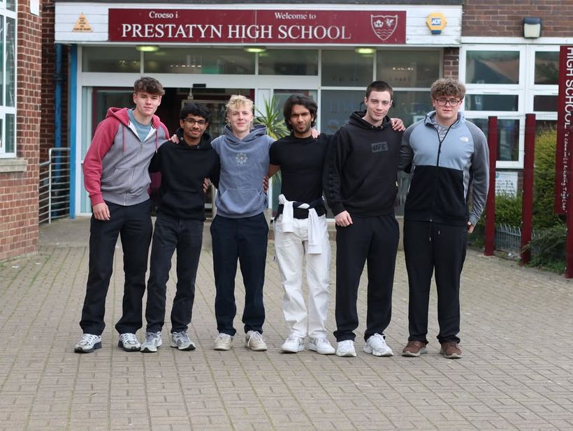 Image shows the group of friends outside their school