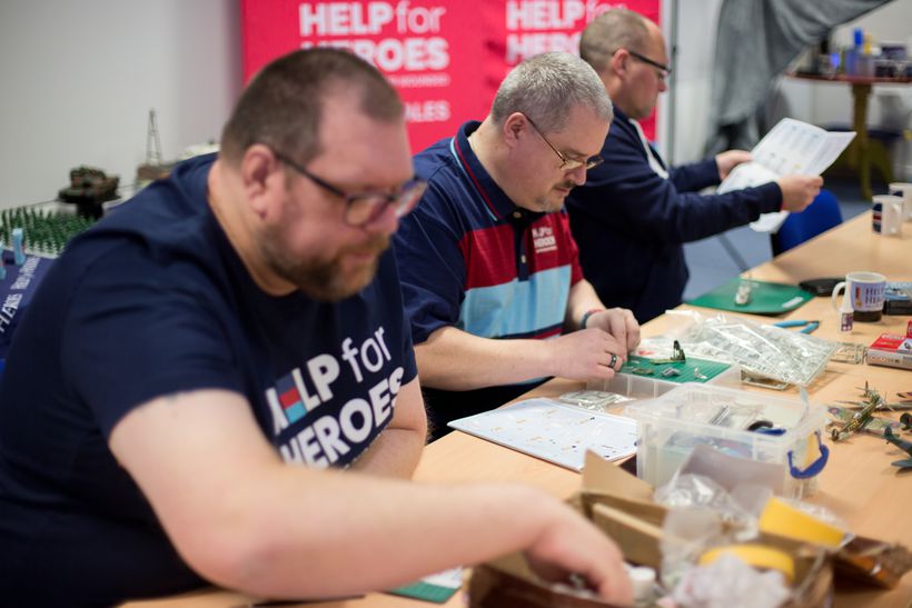 Photo shows three veterans taking part in a community activitiy