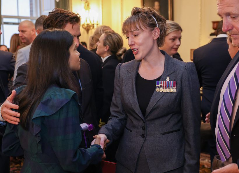 Veteran Megan Lloyd shaking hands with Akshata Murty