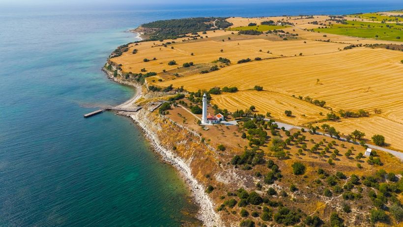 The entrance of a body of water with fields on one side