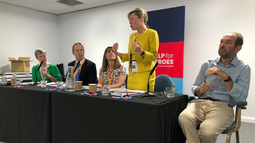 Baroness Smith standing up behind table next to other panellists