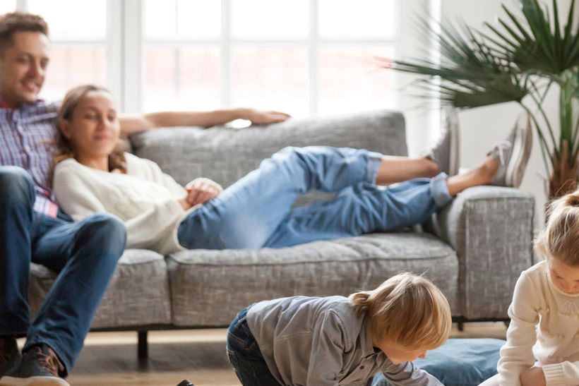 Young family with two children relaxing in their lounge