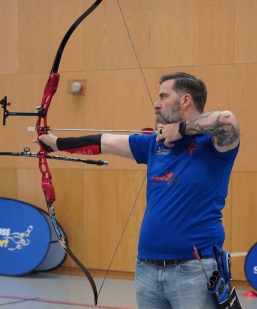Photo shows Darren Forsythe taking part in an archery club