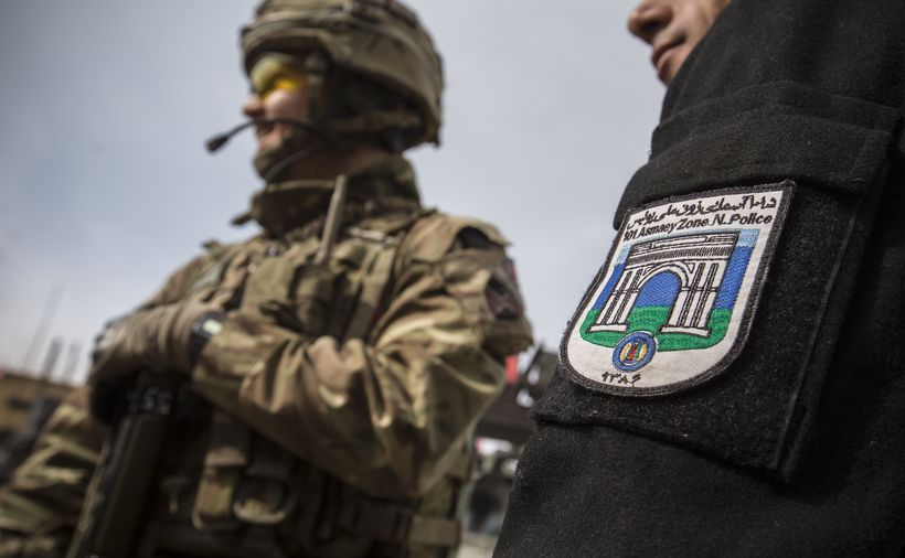 British soldier and Afghan Policeman stand shoulder to shoulder