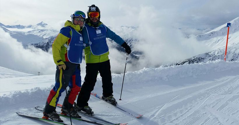 Veteran, Dan Richards (right), skiing