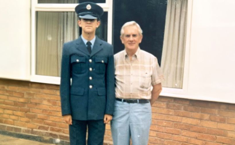 Mike stands in his military uniform, next to his uncle