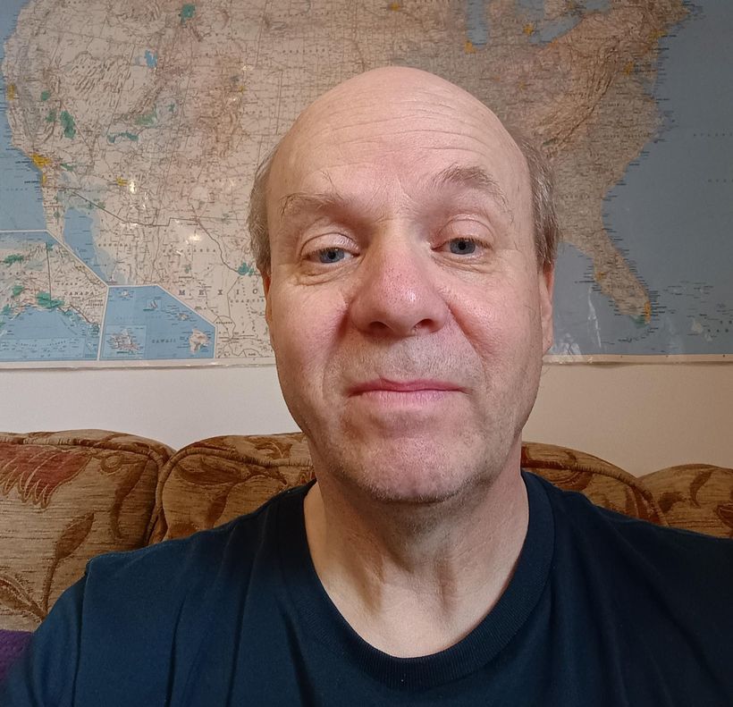 Image shows Kevin wearing a dark blue T-shirt