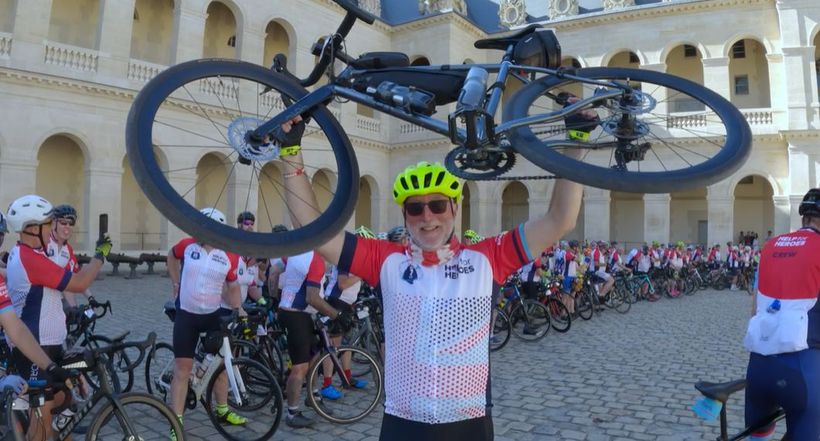 Image of man celebrating end of ride by holding a bike above his head, then video on what the Big Battlefield Bike Ride is.