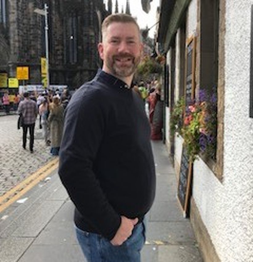 Image shows Robbie Cuthill stood in a busy high street