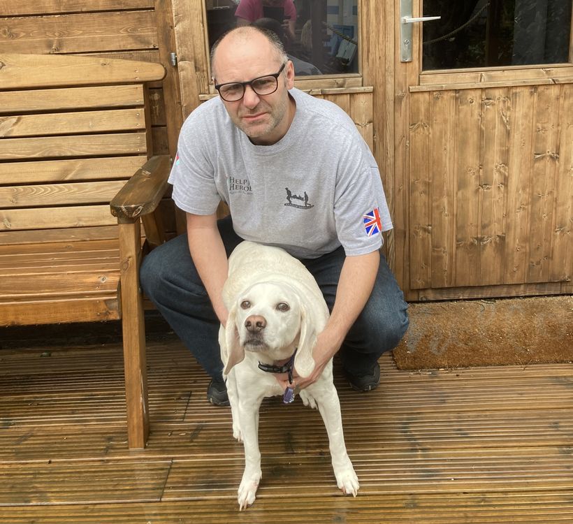 Photos shows Steve Gallagher in his garden, with his dog