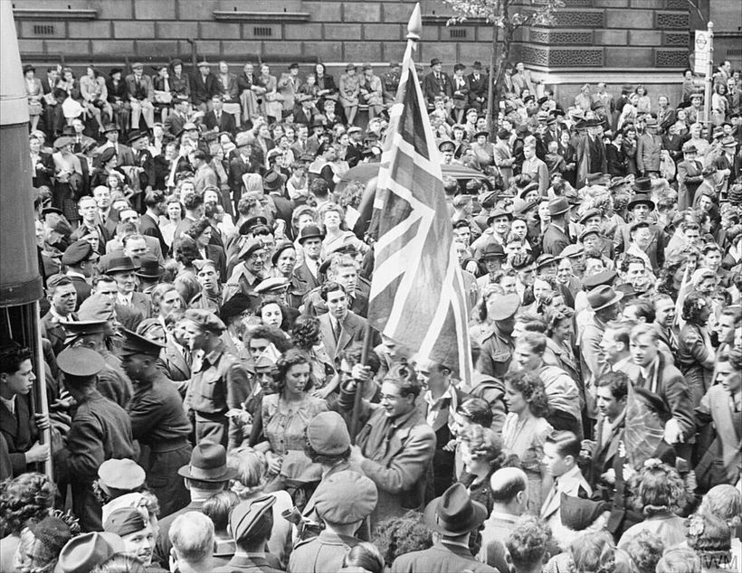 A large crowd of people in London celebrating VE Day