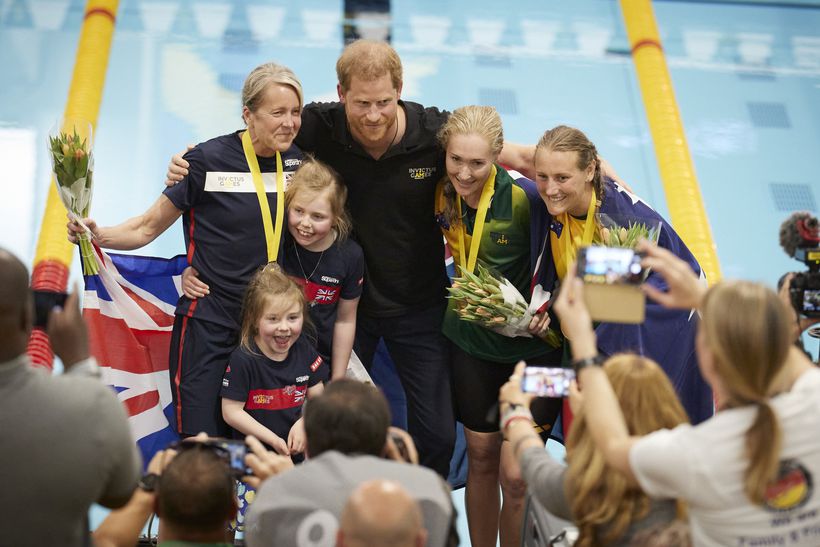 Sally Renard presented with a medal by Prince Harry.