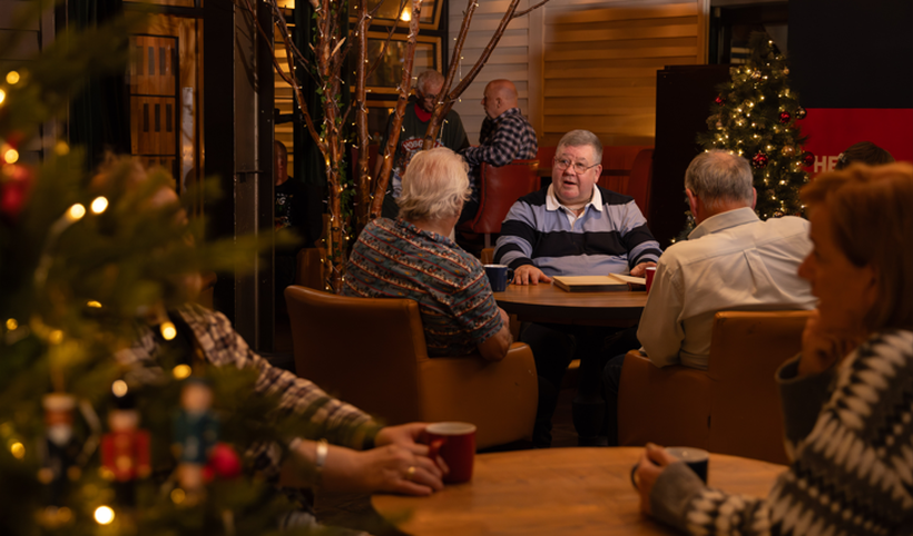 Paul sits in a pub with friends at Christmas
