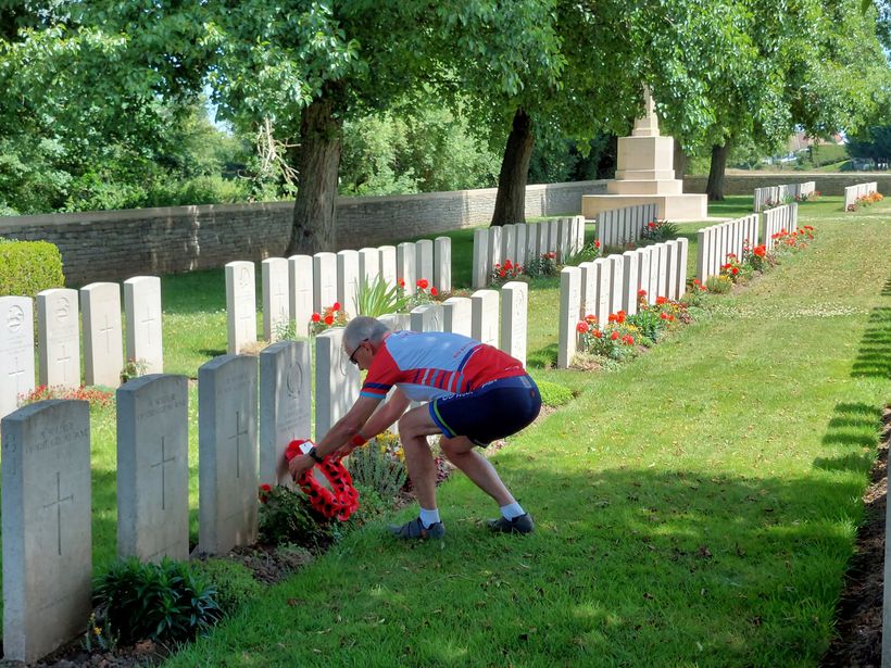 Man laying a wreath at CWG cemetery