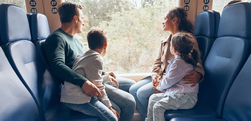 Family of four sat on a train looking out the window