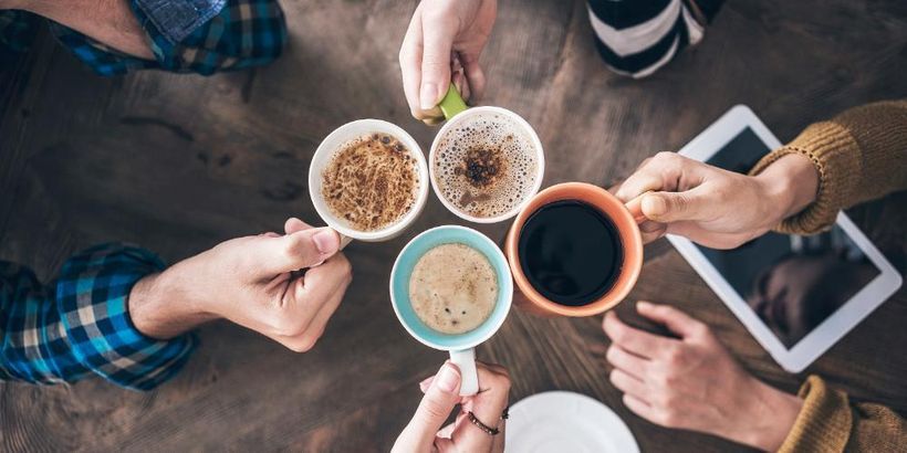 Image shows four cups being held together in a circle