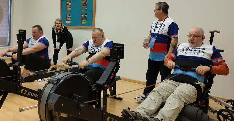 Veterans taking part in an indoor rowing race.