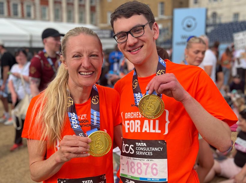 Mum and son show off medals after completing the marathon