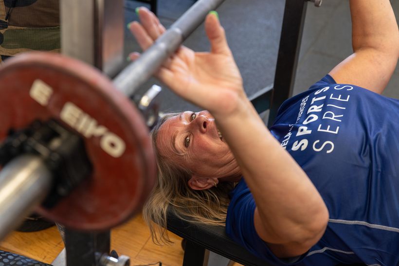 Photo shows female veteran taking part in power-lifting coaching