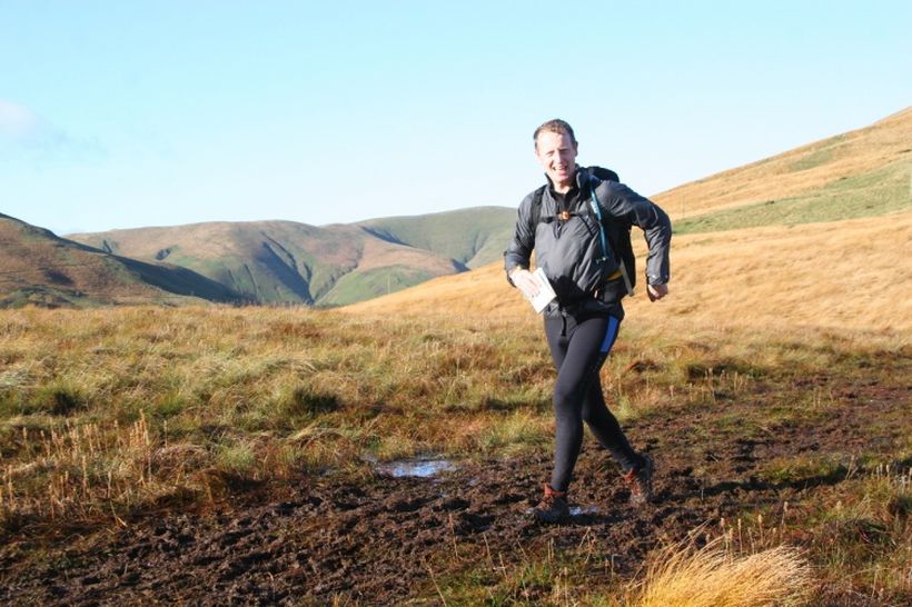 Rob runs across the hilly countryside